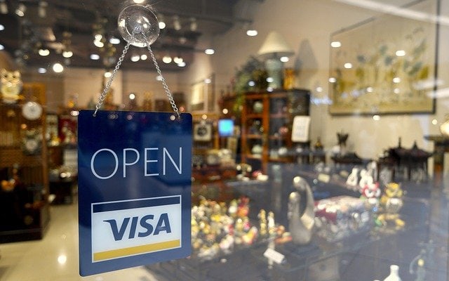 store open with a VISA sign